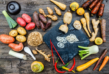 Asian lotus root began to be used in world kitchens. Slicies on old black stone deck on old wooden background, Miso Soup with Winter Vegetables