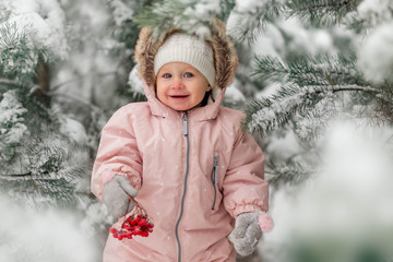 little girl walks in winter forest