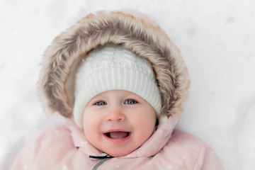 little girl walks in winter forest