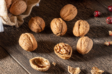 Whole and broken walnuts on a table