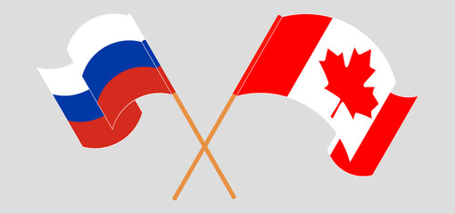 Crossed and waving flags of Canada and Russia