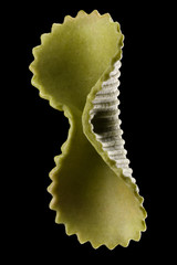 Macro photo of green farfalle pasta isolated on black with clipping path