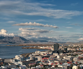 Beautiful wide angle aerial view Reykjavik Iceland cityscape and Faxafloi Bay with capital city skyline and sweeping high view of capital region, Reykjavik Harbour Harbor mountains and water.