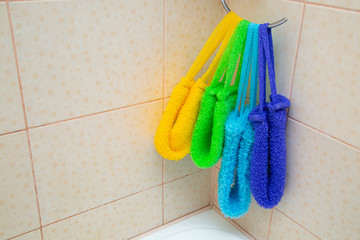 Washcloths colored hanging in the bathroom. Using a washcloth for washing.