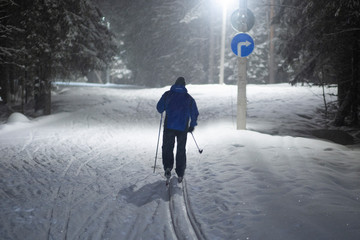 Snowfall at night. Cross country ski.Skiing at night by the light of lamps in the snow.