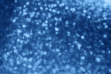 Festive classic blue abstract background with defocused circular bokeh.