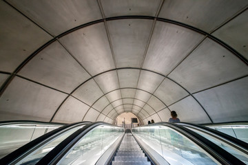 Travelling underground. Escalators leading to a subway station