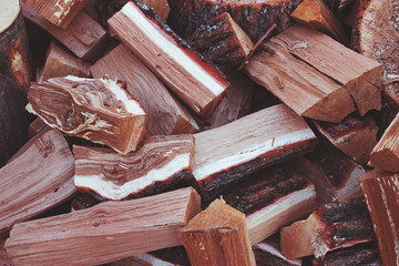 pile of split logs for fire, tinted image