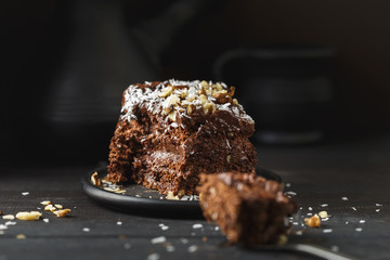 Chocolate cake in black plate on wooden table