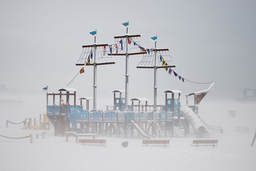 In the children's playground there is a ship that is snow-covered in winter and wrapped in fog, reminiscent of a fairy-tale house lonely nowhere