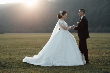 The bride feeling happy. Happy couple. Wedding photo. Couple in love. Bride and groom on their wedding, photo session. Bride and groom are standing face to face