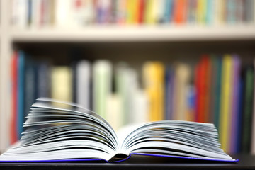 open book on bookshelf background