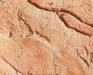 Fragment of an old wall made of red clay. Abstract old background.