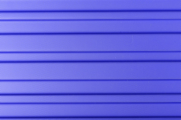 Classic blue color 2020. Texture of striped plastic, metal hi-tech raw future lightweight material. Classic blue background, blue toning. Abstract trendy background mock up with copy space for text.