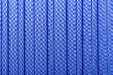 Classic blue color 2020. Texture of striped plastic, metal hi-tech raw future lightweight material. Classic blue background, blue toning. Abstract trendy background mock up with copy space for text.
