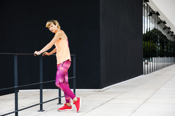 Fototapeta na wymiar Young sporty woman dressed in sportswear doing her workout outdoors. Healthy Lifestyle