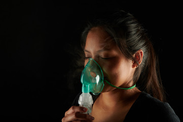Face of latin woman with inhale mask