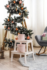 lots of Christmas trees in the bright cozy room. copy space