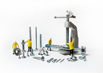 Construction crew with mounting material of different calibers on a white background. People are dolls.