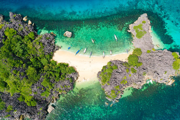 Travel concept: tropical sand beach and turquoise water view from the top. Lahos Island, Caramoan Islands, Philippines. Summer and travel vacation concept.