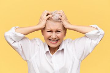 Stress, problems, anger, fury and negative emotions. Frustrated desperate mature female screaming...