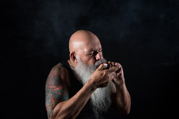older man with beard smoking