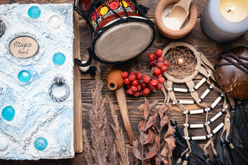 Fototapeta na wymiar Witch doctor or shaman table flat lay background. Magic book on the witch desk.