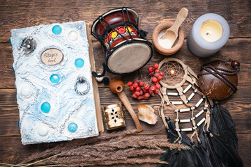 Witch doctor or shaman table flat lay background. Magic book on the witch desk.