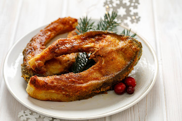 Christmas carp, Fried carp fish slices on a white plate. Traditional christmas eve dish. Polish Christmas