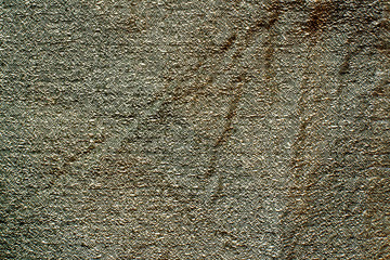 Color fabric texture. Rough fabric with a crumpled surface in a green hue. Copy space