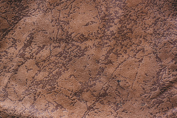 Color fabric texture. Soft crumpled brown fabric with spots like cracks. It looks like swamps on a map. Copy space.