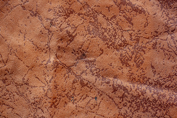 Color fabric texture. Soft crumpled brown fabric with spots like cracks. It looks like a map with lakes. Copy space.