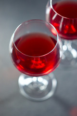  glasses with red wine on a blurry gray background