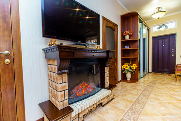 Electric fireplace between the doors. Over the fireplace TV