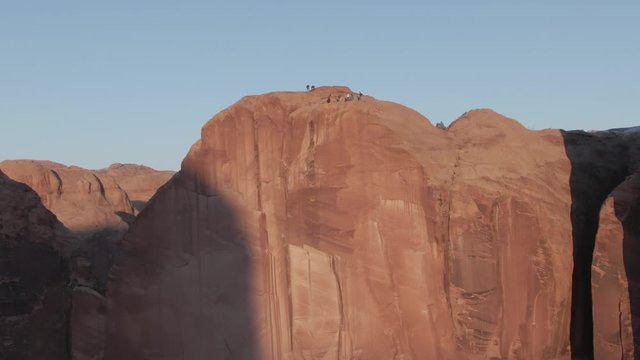 BASE jumpers on a cliff at Sunset