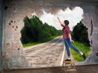 Girl with paint roller and the road to nature from the old apartment. Concept
