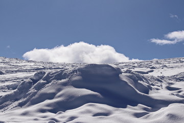 Fototapeta premium snowy mountain side and deep blue sky