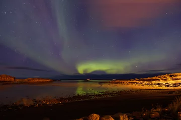 Foto op Aluminium what a beautiful moment of the northern lights, a wave of greenery in the sky with the beach in the foreground and a reflection in the lake  © Dasya - Dasya