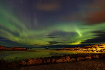 Foto op Aluminium Special and so beautiful nothern light in green, blue and orange colours, above a lake in Bourganes, with reflection in the water, Iceland © Dasya - Dasya