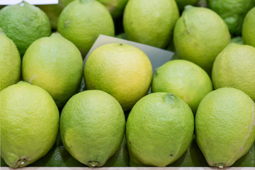 Fresh ripe green limes on wooden box