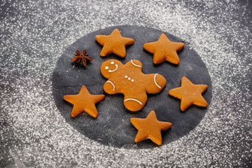 Various christmas gingerbread cookies on dark table