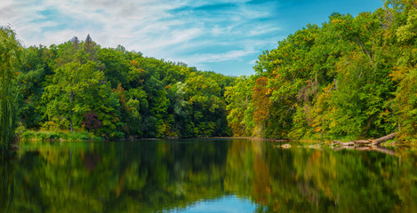 Trees with bright autumn foliage reflected in the water.