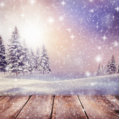 Empty winter christmas scenic landscape with copy space.Wooden table with snow and fir-trees covered with snow on nature
