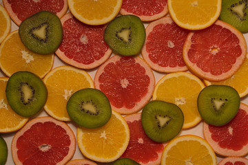 Fototapeta na wymiar Fruit background from oranges, grapefruit, kiwi..