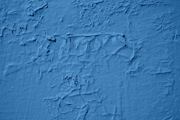 old peeling paint on wooden background. Classic blue color.
