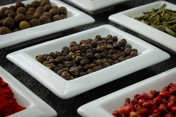 Black pepper. Colorful spices in white bowls Seasonings for cooking. Natural Herbs & Spices.