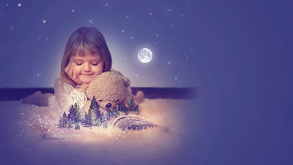 Little girl with her teddy bear, watching a enchanted forest  on the pages of an open magic book;...