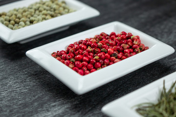 Red pepper or Pink pepper. Colorful spices in white bowls Seasonings for cooking. Natural Herbs & Spices.