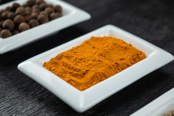 Turmeric powder. Colorful spices in white bowls Seasonings for cooking. Natural Herbs & Spices.