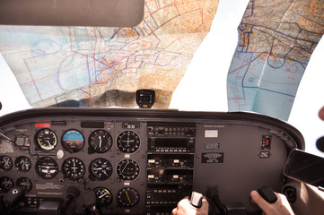Pilots in flight deck with charts all over the cockpit trying to navigate